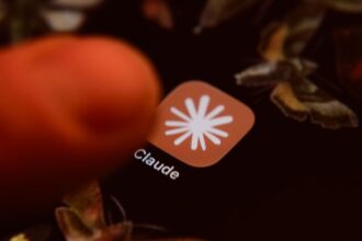 Smartphone displaying Claude AI app icon on screen