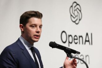 Brad Lightcap speaking at a technology conference podium